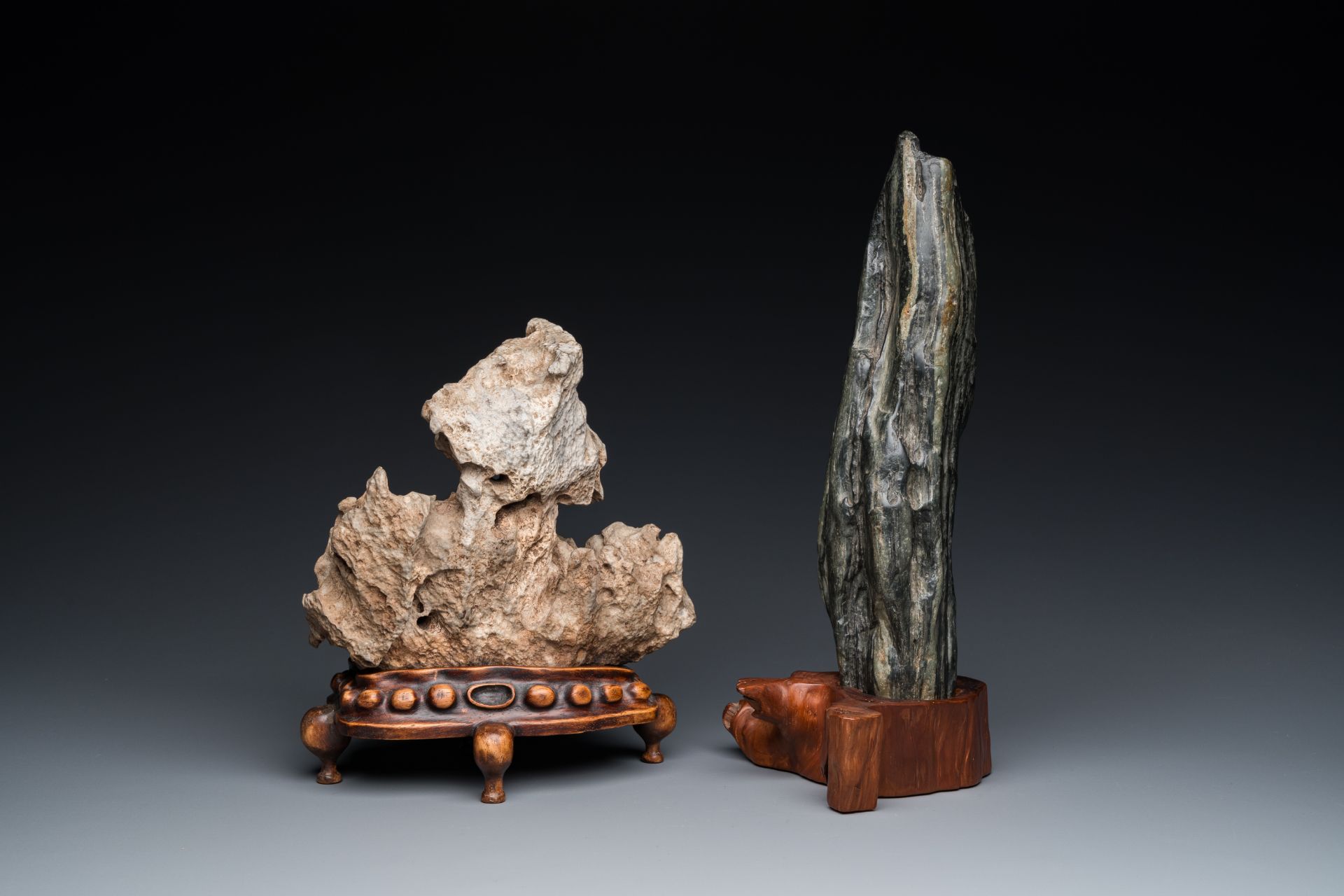 Two Chinese 'gongshi or 'scholar's rocks' on wood stands, Ming or later