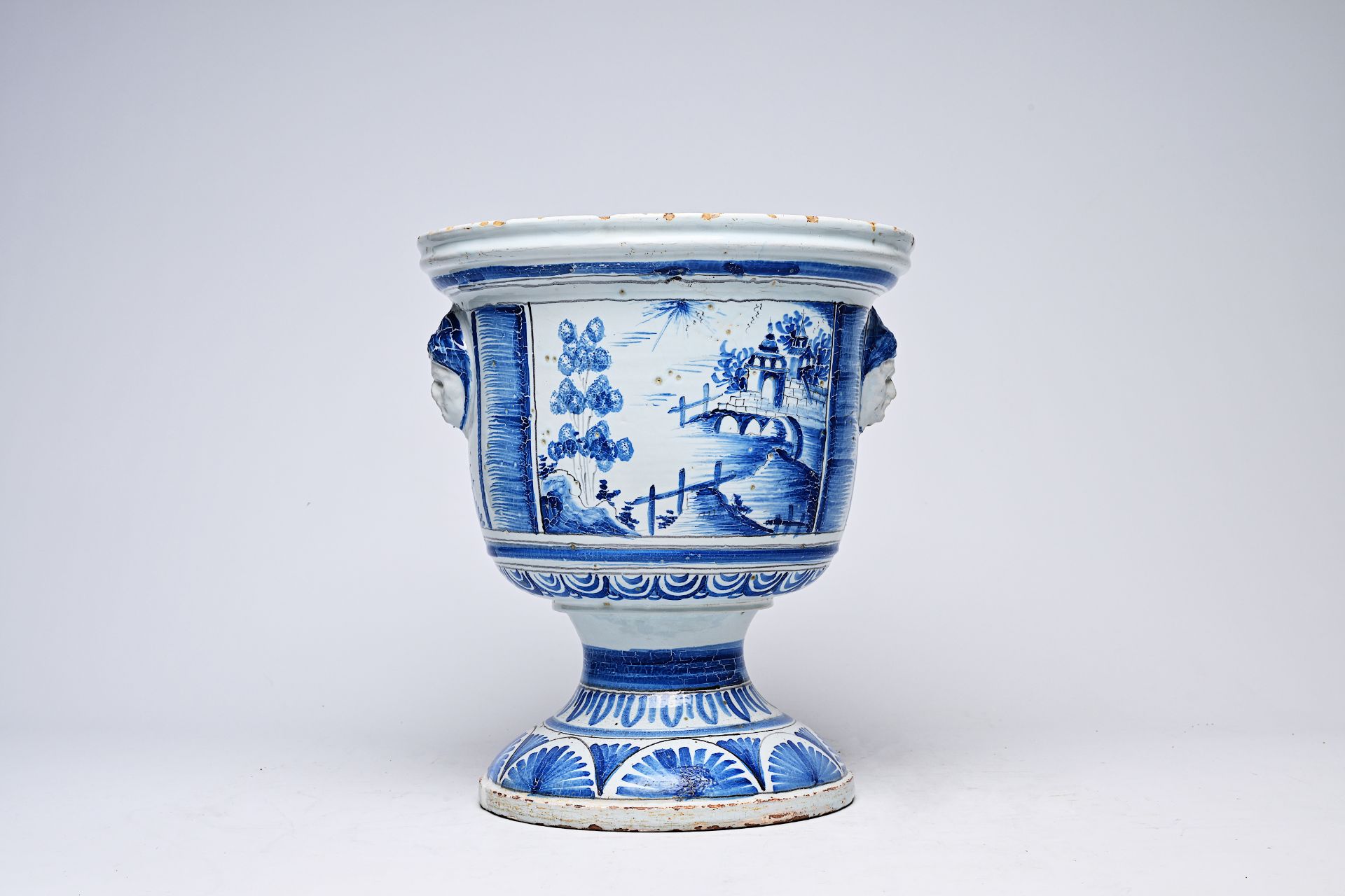 A French blue and white vase on stand with oriental landscapes and mascarons, Nevers, 18th C.