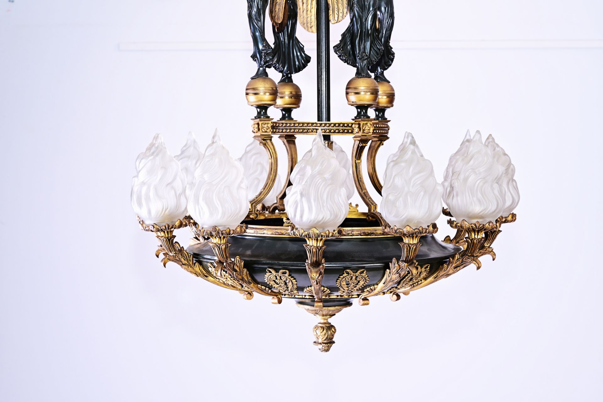 A French patinated and gilt bronze Empire style twelve-light 'caryatids' chandelier, 19th C. - Image 2 of 7