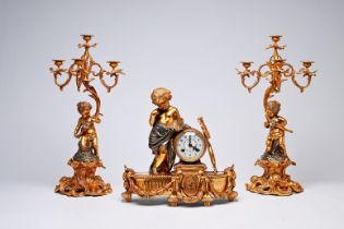 A French three-piece partly gilt metal clock garniture with putti, 20th C.