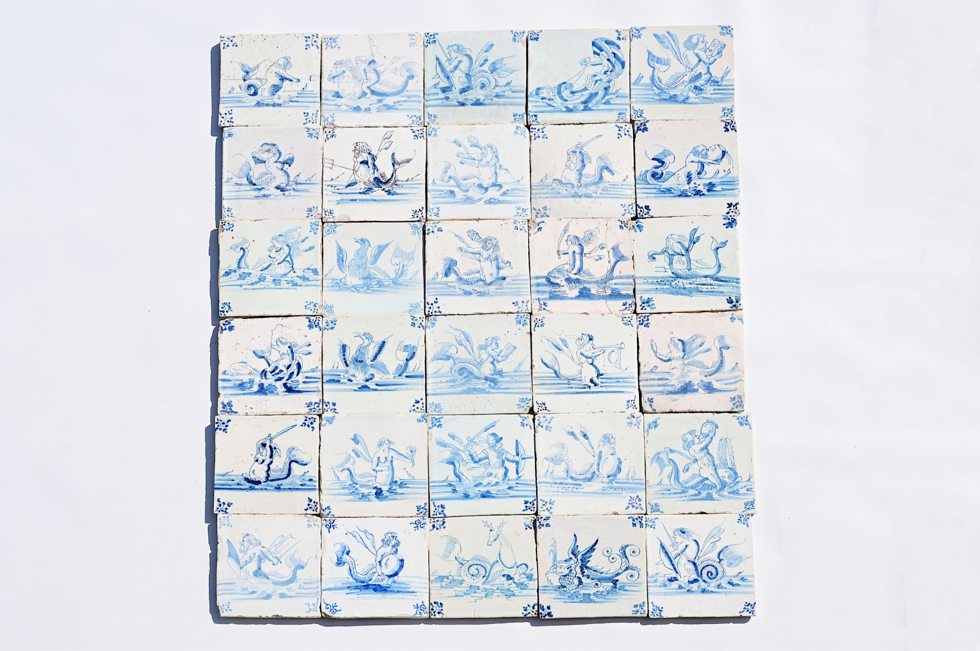 Thirty Dutch Delft blue and white 'sea monster' tiles, 17th C.