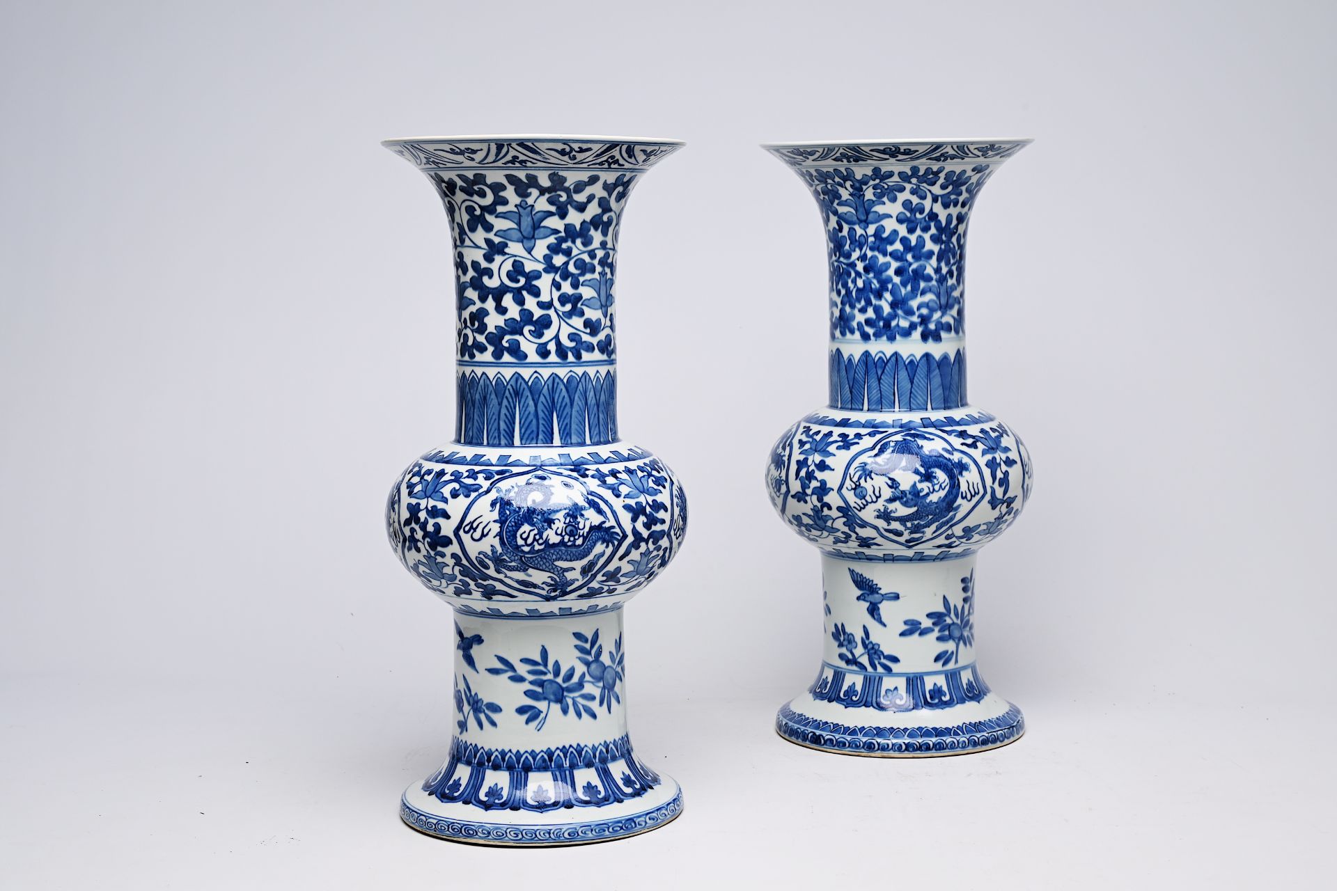 A pair of Chinese blue and white 'gu' vases with dragons and floral design, Qianlong mark, Republic, - Image 12 of 22