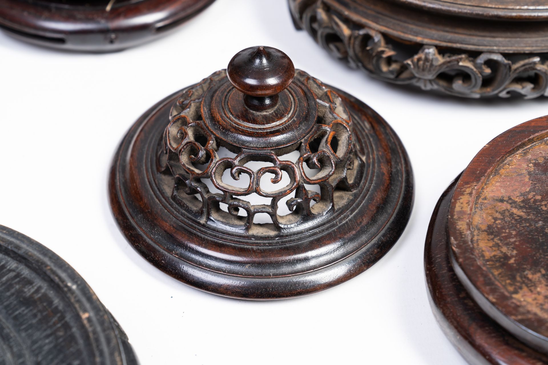 A varied collection of Chinese carved wood stands and covers, 19th/20th C. - Image 3 of 4
