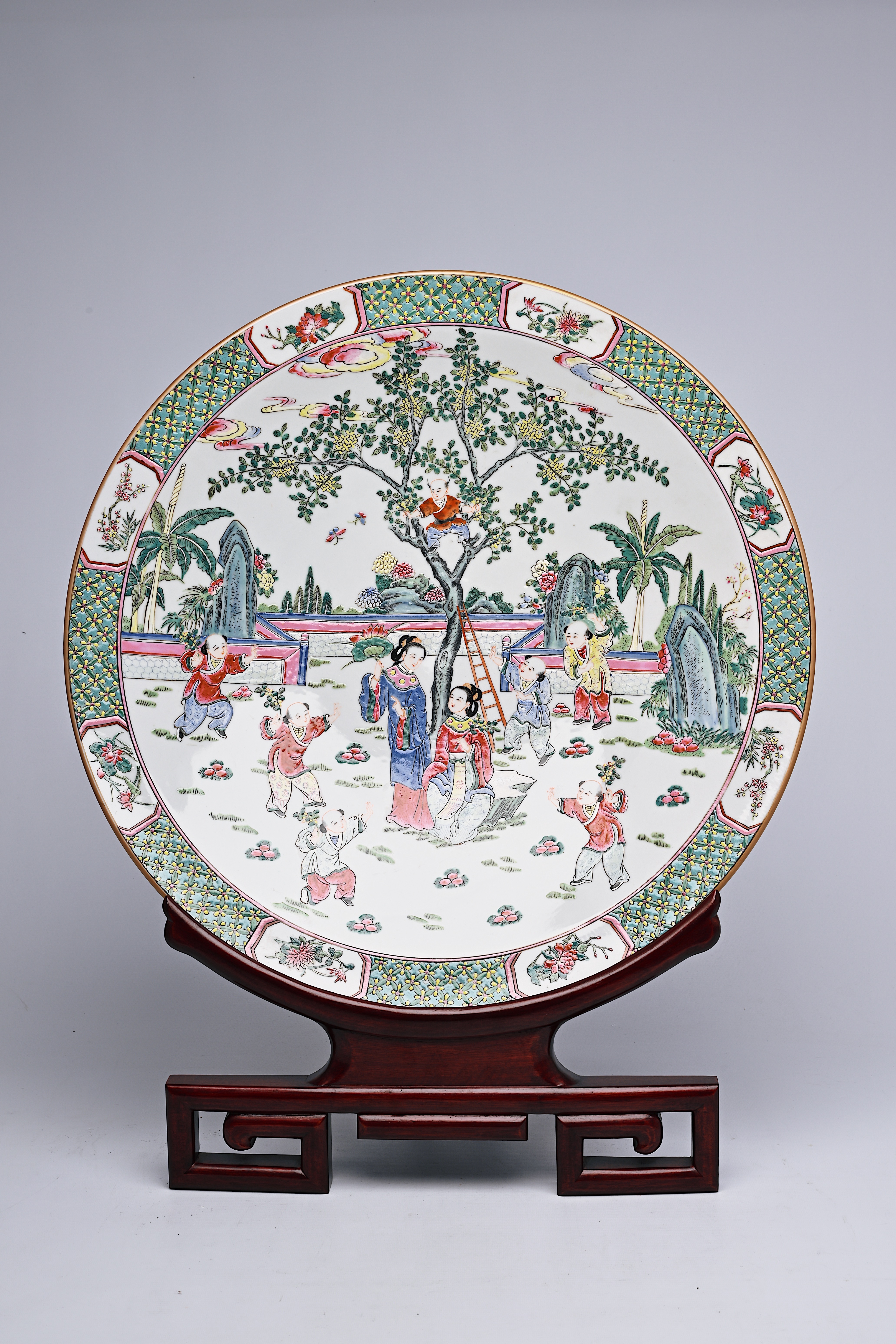 A large Chinese famille rose dish with ladies and children in a landscape, Qianlong mark, 20th C. - Image 6 of 16