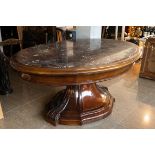 An impressive oval English mahogany table with marble top, 19th C.