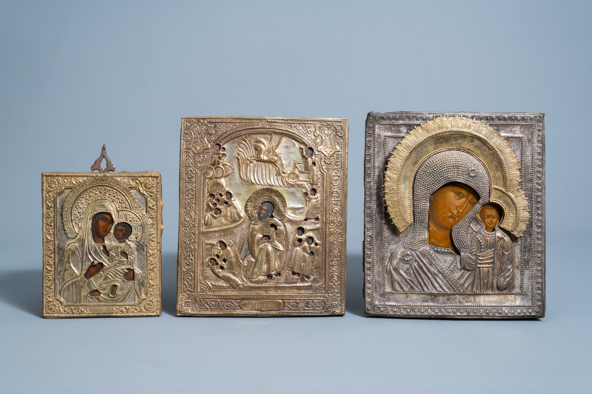 Two Russian 'Mother of God' icons and an 'Ascension of Elijah into the heavens' icon with copper okl