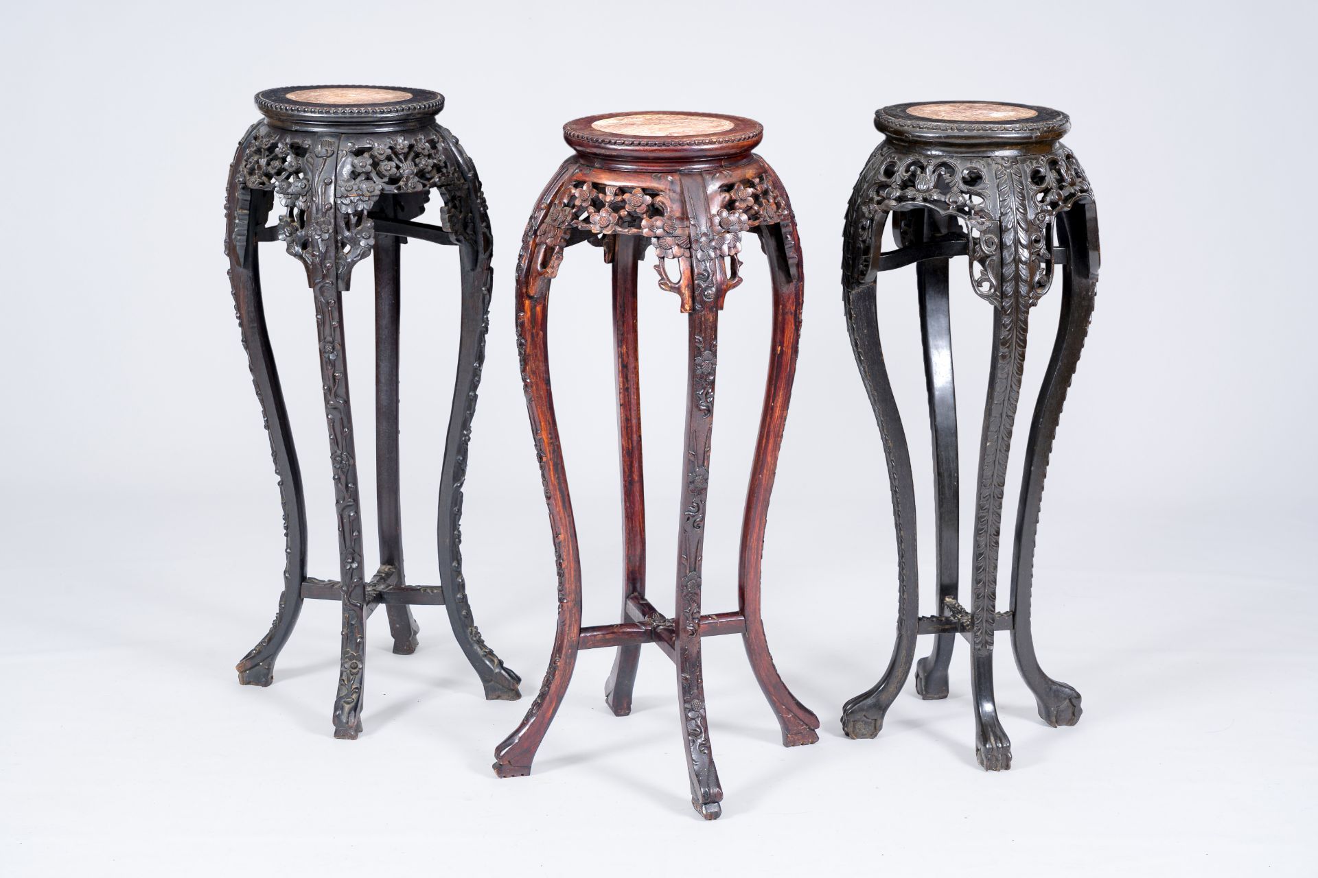 Three Chinese reticulated hardwood stands with marble tops, 19th/20th C.