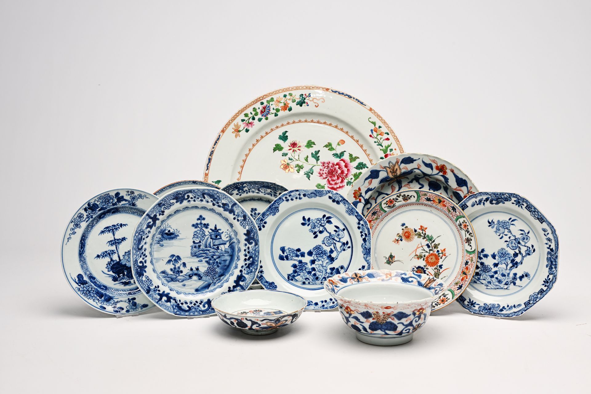 A varied collection of Chinese famille rose, blue, white and Imari style porcelain with landscapes a