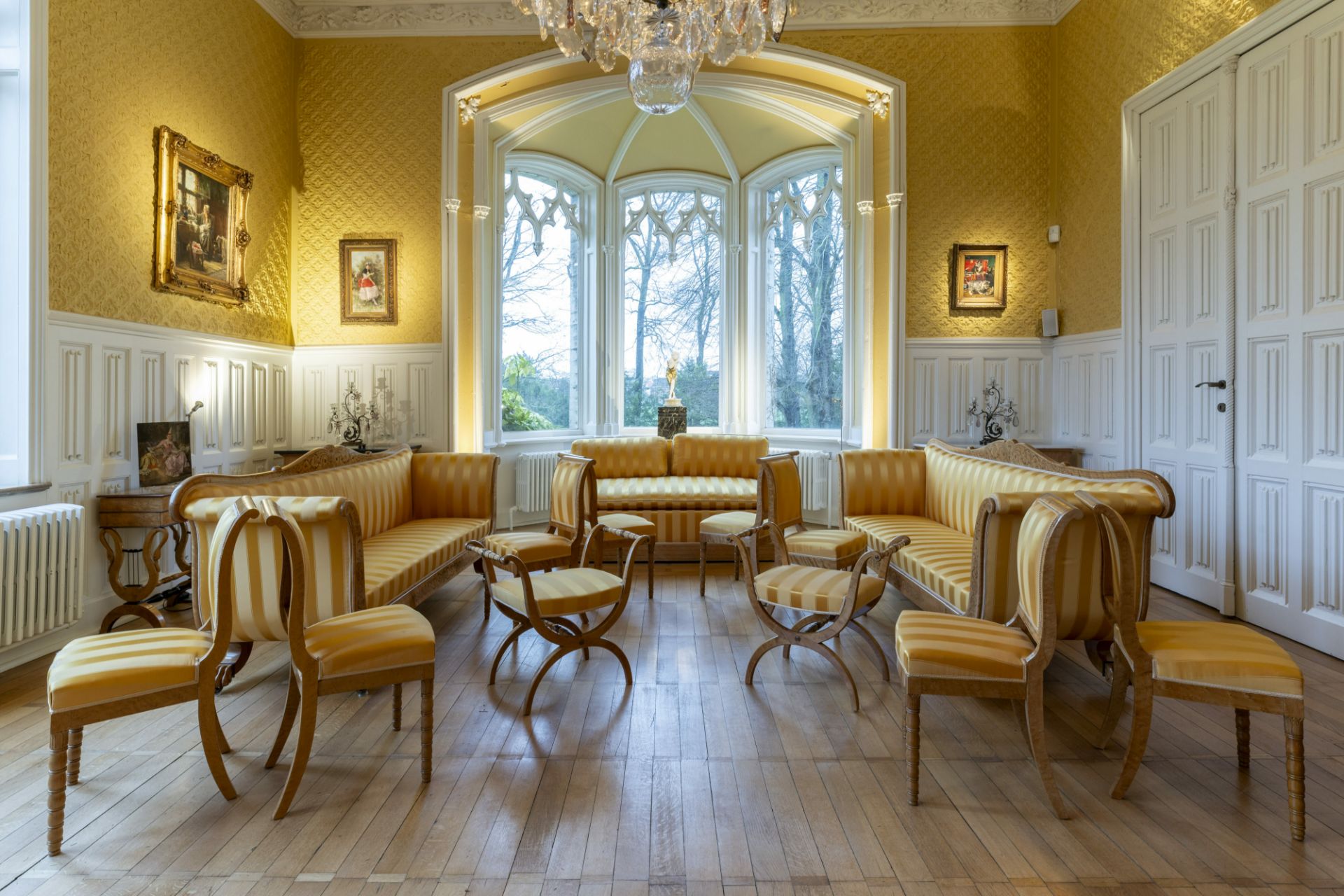 A 13-piece Biedermeier salon set comprising 3 sofas, 8 chairs and 2 footstools with yellow silk upho