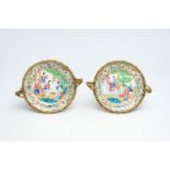 Two Chinese Canton famille rose gilt bronze mounted plates with figures on a terrace, 19th C.