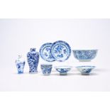 A varied collection of Chinese blue and white porcelain with floral design and figures in a landscap