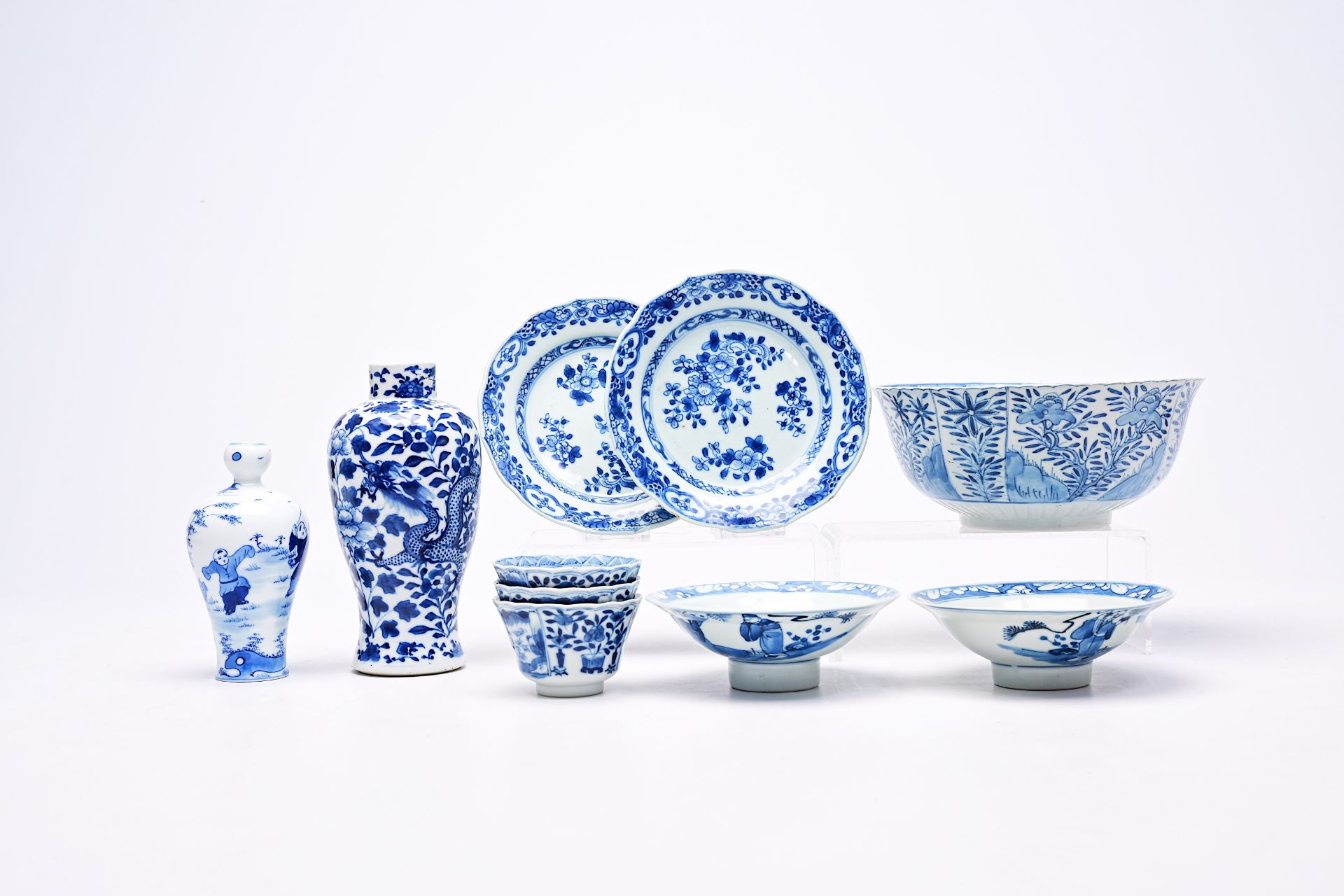 A varied collection of Chinese blue and white porcelain with floral design and figures in a landscap