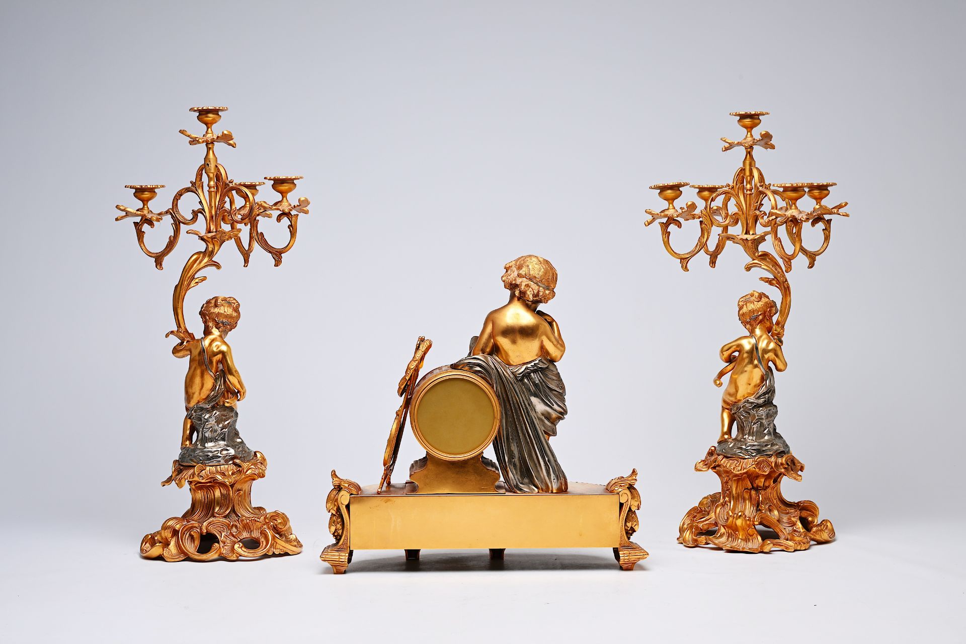 A French three-piece partly gilt metal clock garniture with putti, 20th C. - Image 4 of 11