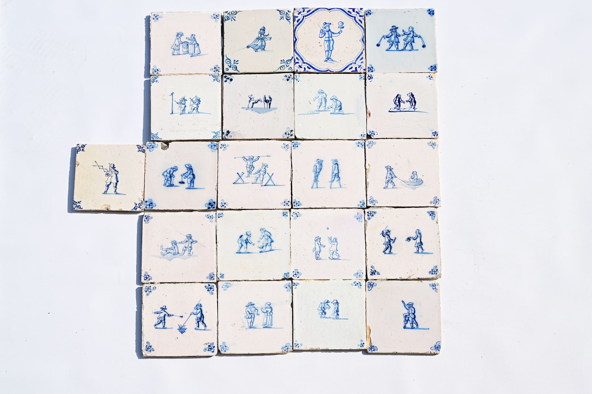 Twenty-one Dutch Delft blue and white 'children's games' tiles, 17th/18th C.