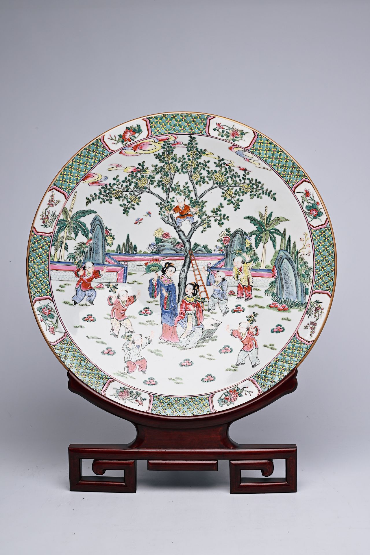 A large Chinese famille rose dish with ladies and children in a landscape, Qianlong mark, 20th C. - Image 5 of 16