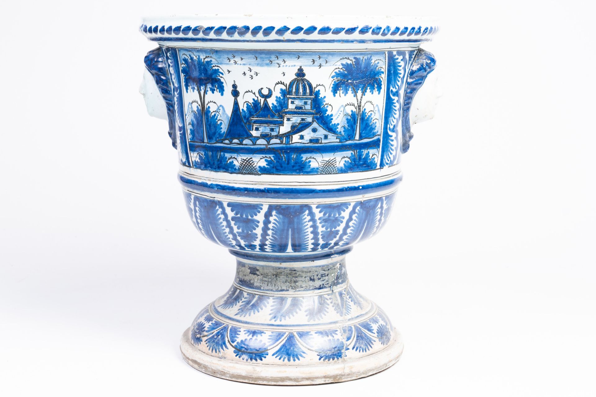 A large French blue and white earthenware Louis XIV vase on stand with oriental landscapes and masca