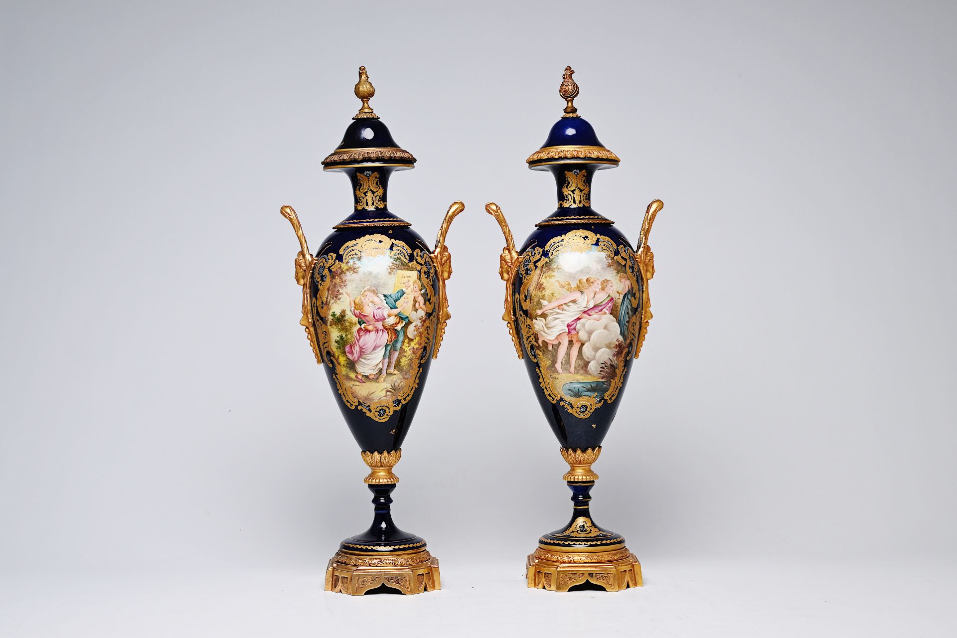 A pair of French gilt bronze mounted gold layered blue ground Sevres style vases and covers with lan