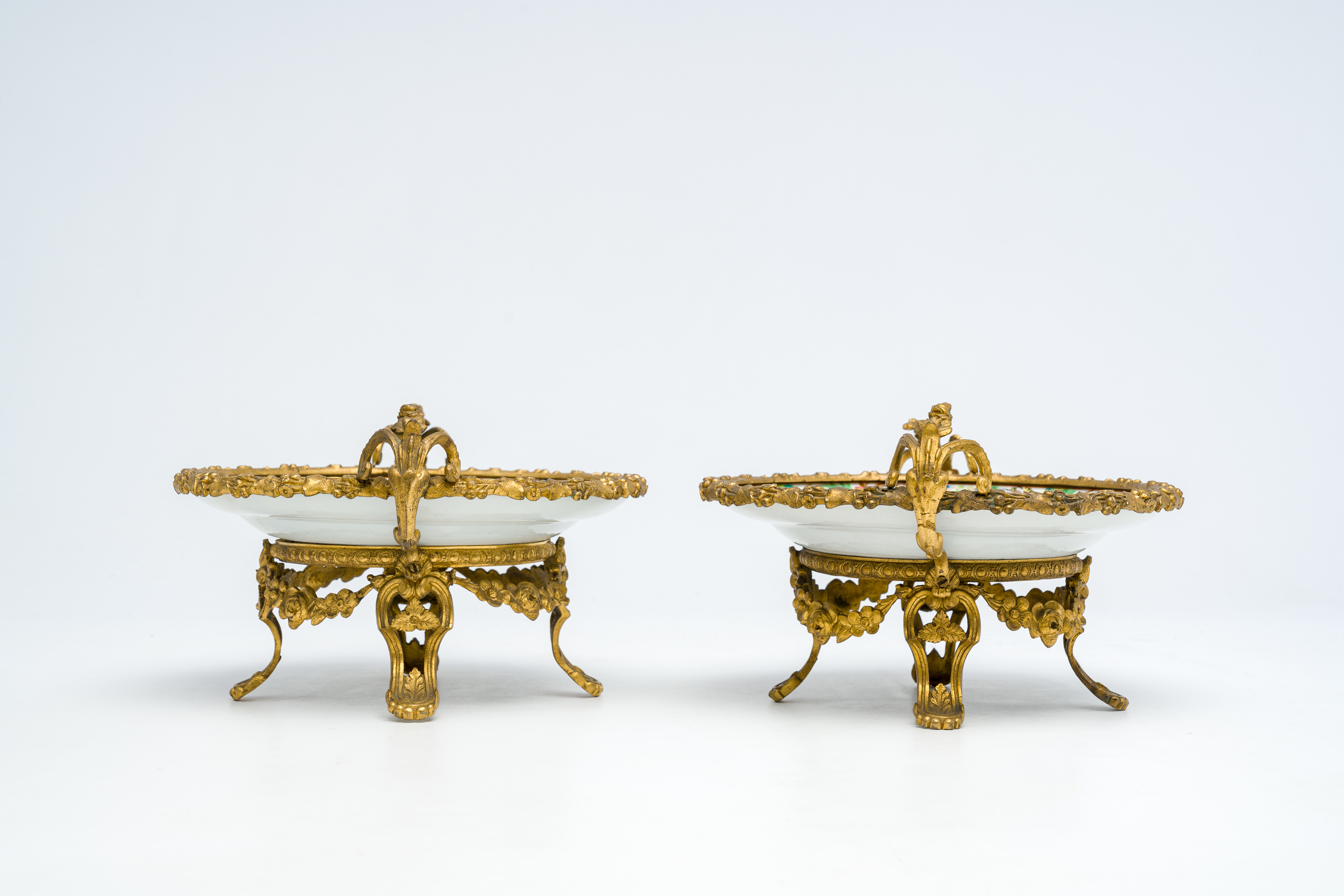 Two Chinese Canton famille rose gilt bronze mounted plates with figures on a terrace, 19th C. - Image 7 of 7