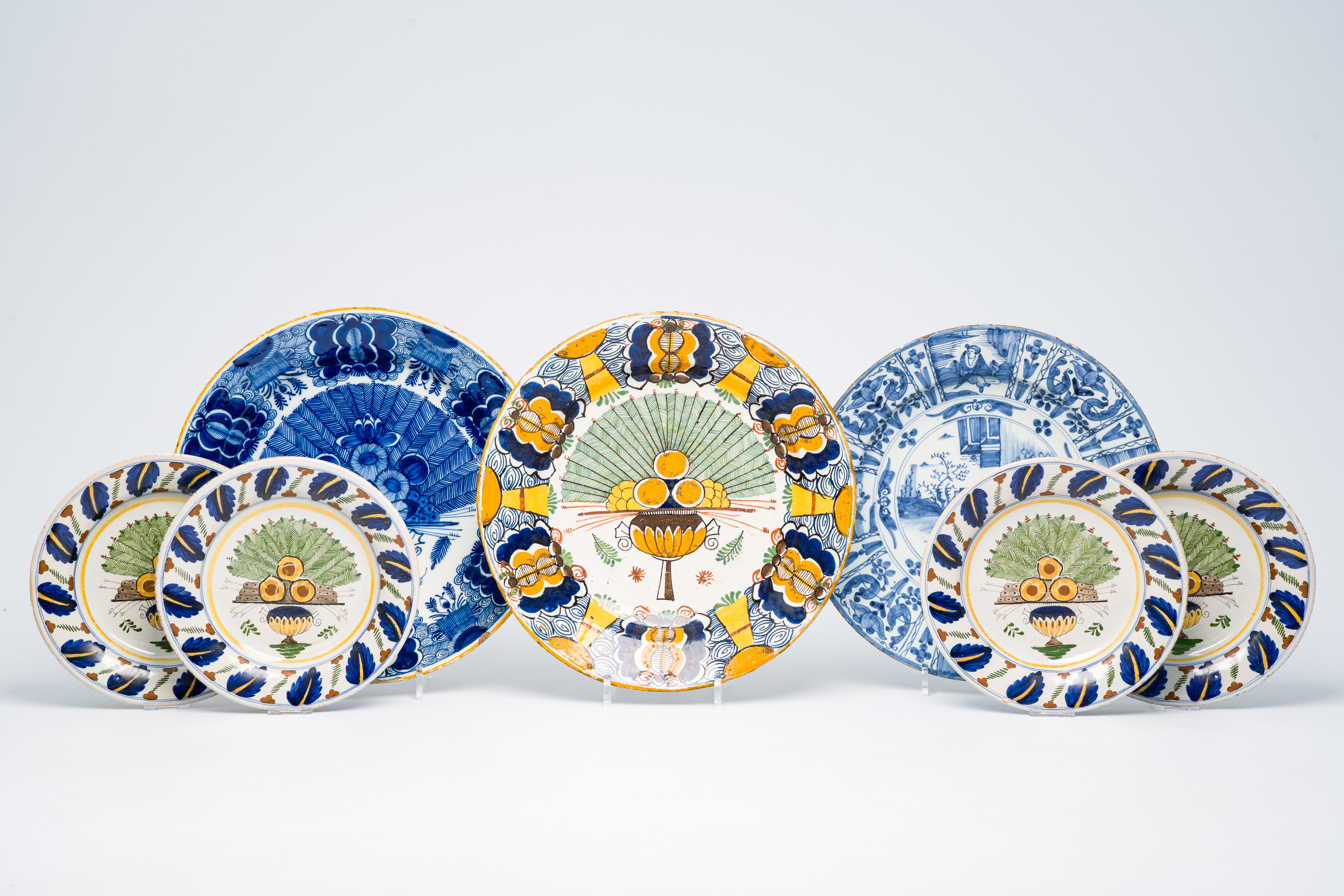 Seven Dutch Delft blue, white and polychrome plates and dishes with floral and chinoiserie design, 1