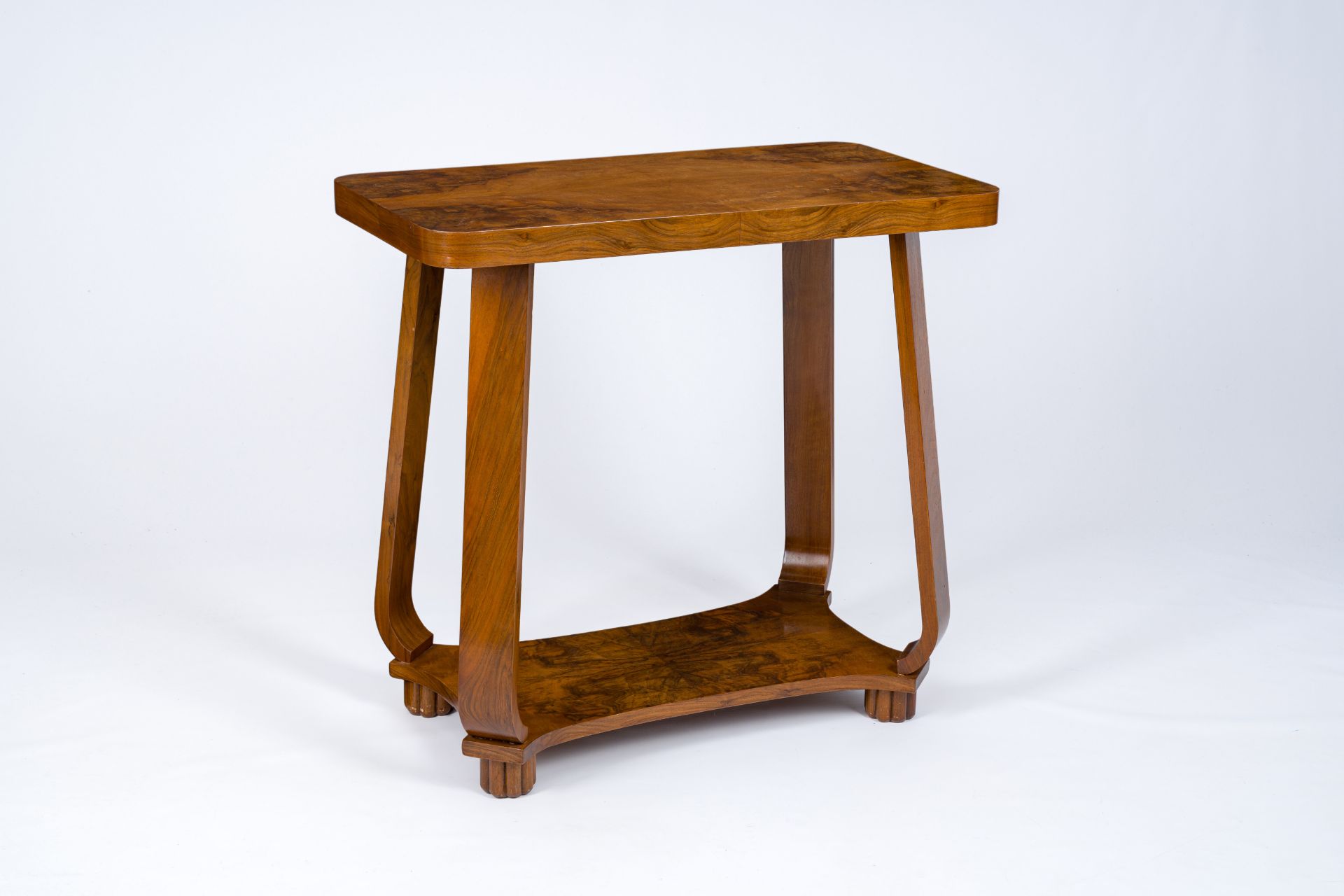 A French Art Deco walnut veneered side table, second quarter 20th C.