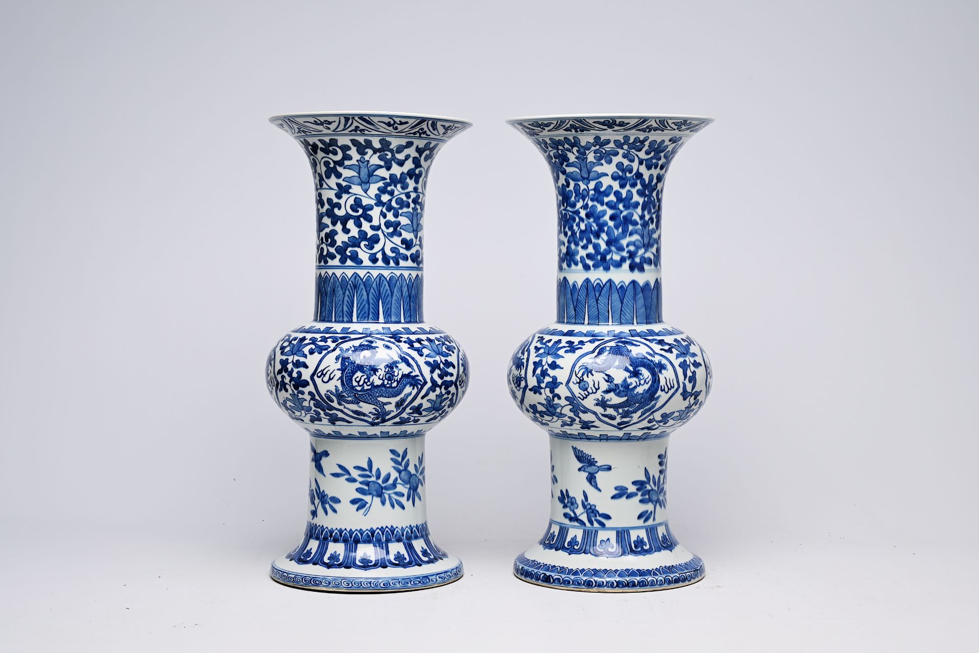 A pair of Chinese blue and white 'gu' vases with dragons and floral design, Qianlong mark, Republic, - Image 10 of 22