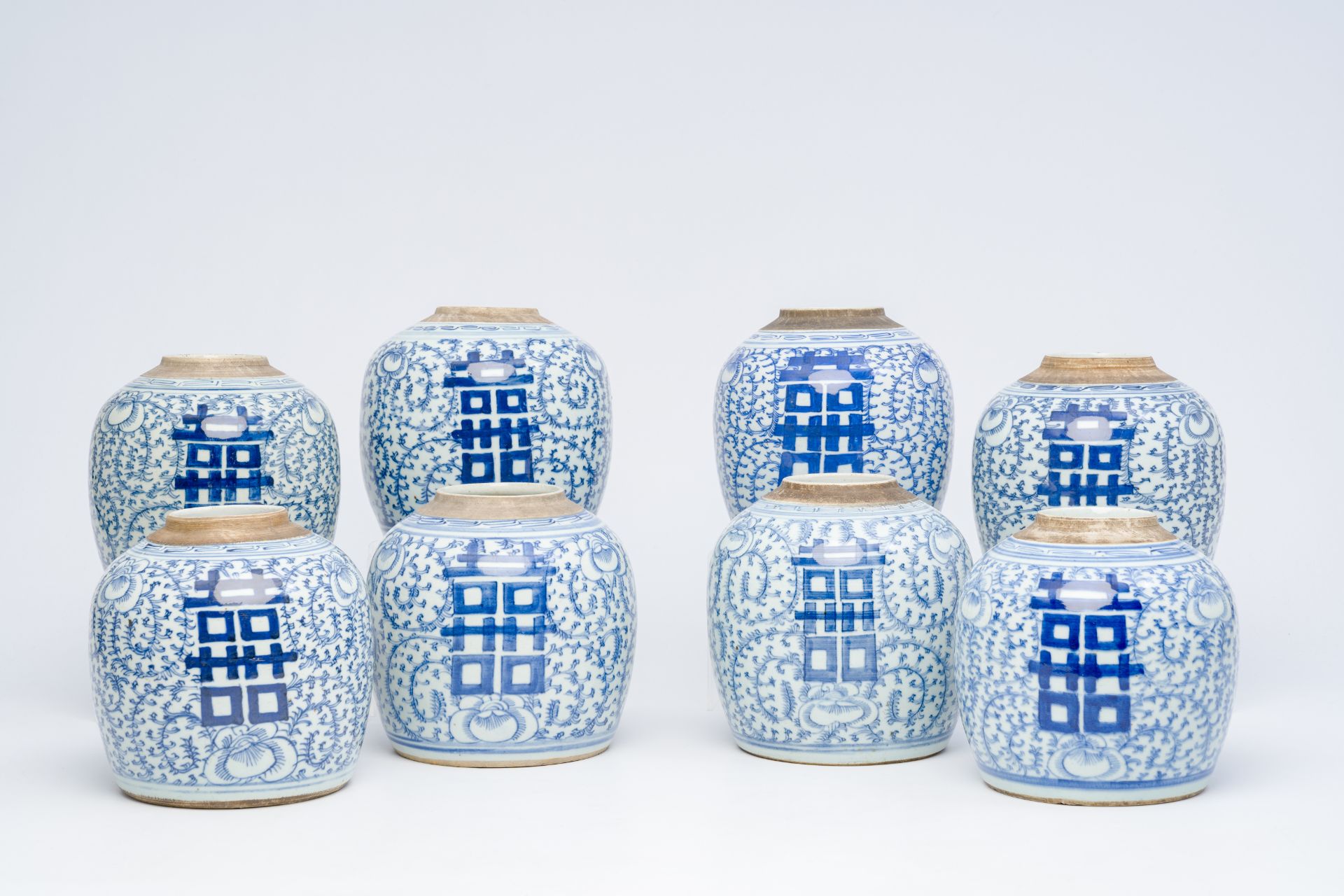 Eight Chinese blue and white ginger jars with 'Xi' and floral design, 19th/20th C.