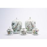 Five various Chinese famille rose and qianjiang cai jars and covers with ladies and children on a te