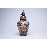 A Japanese Imari vase and cover with birds among blossoming branches and crowned with a lady, Edo, 1