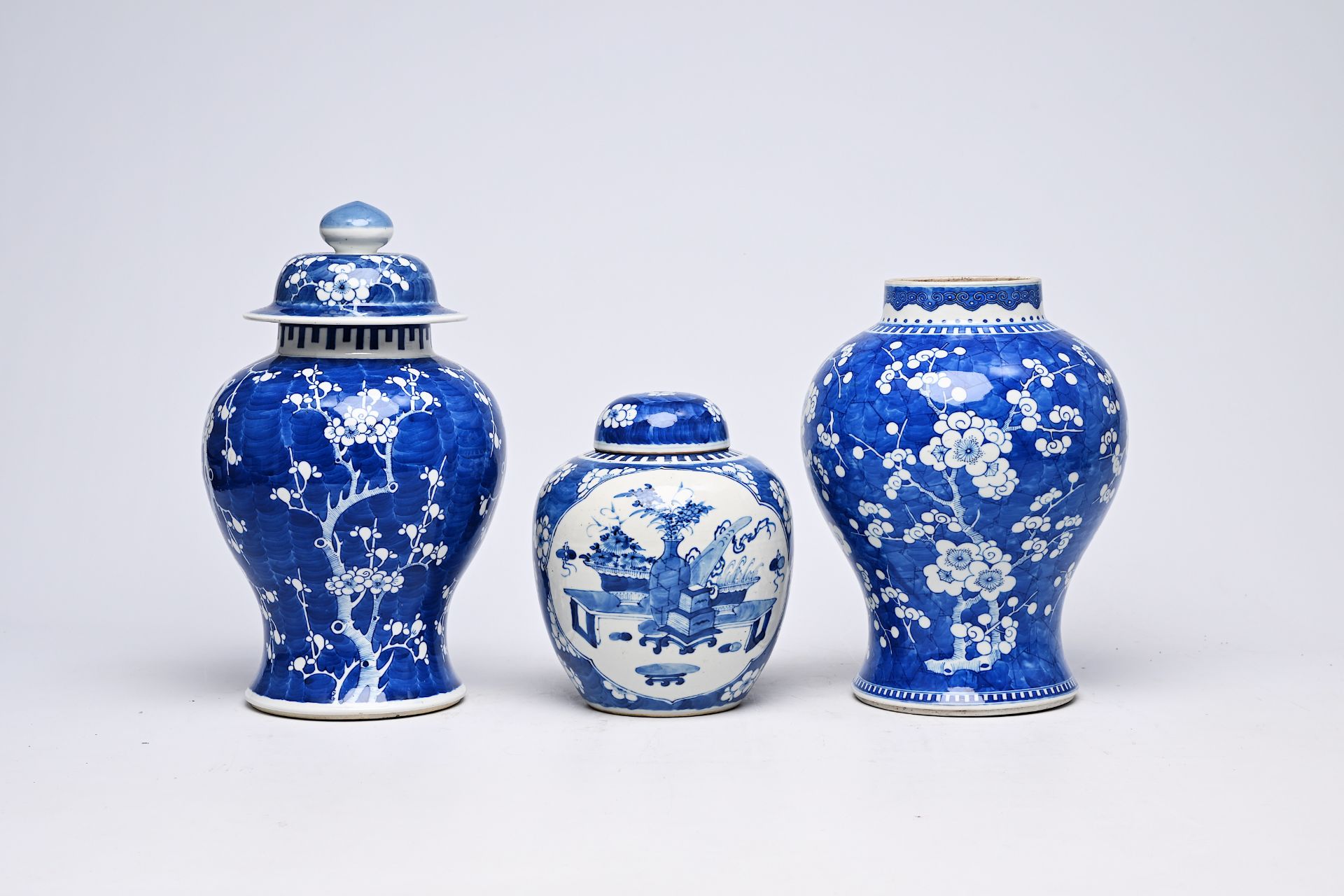 Two Chinese blue and white prunus on cracked ice ground vases and a jar and cover with antiquities,