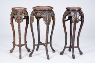 Three Chinese reticulated hardwood stands with marble tops, 20th C.