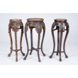 Three Chinese reticulated hardwood stands with marble tops, 20th C.