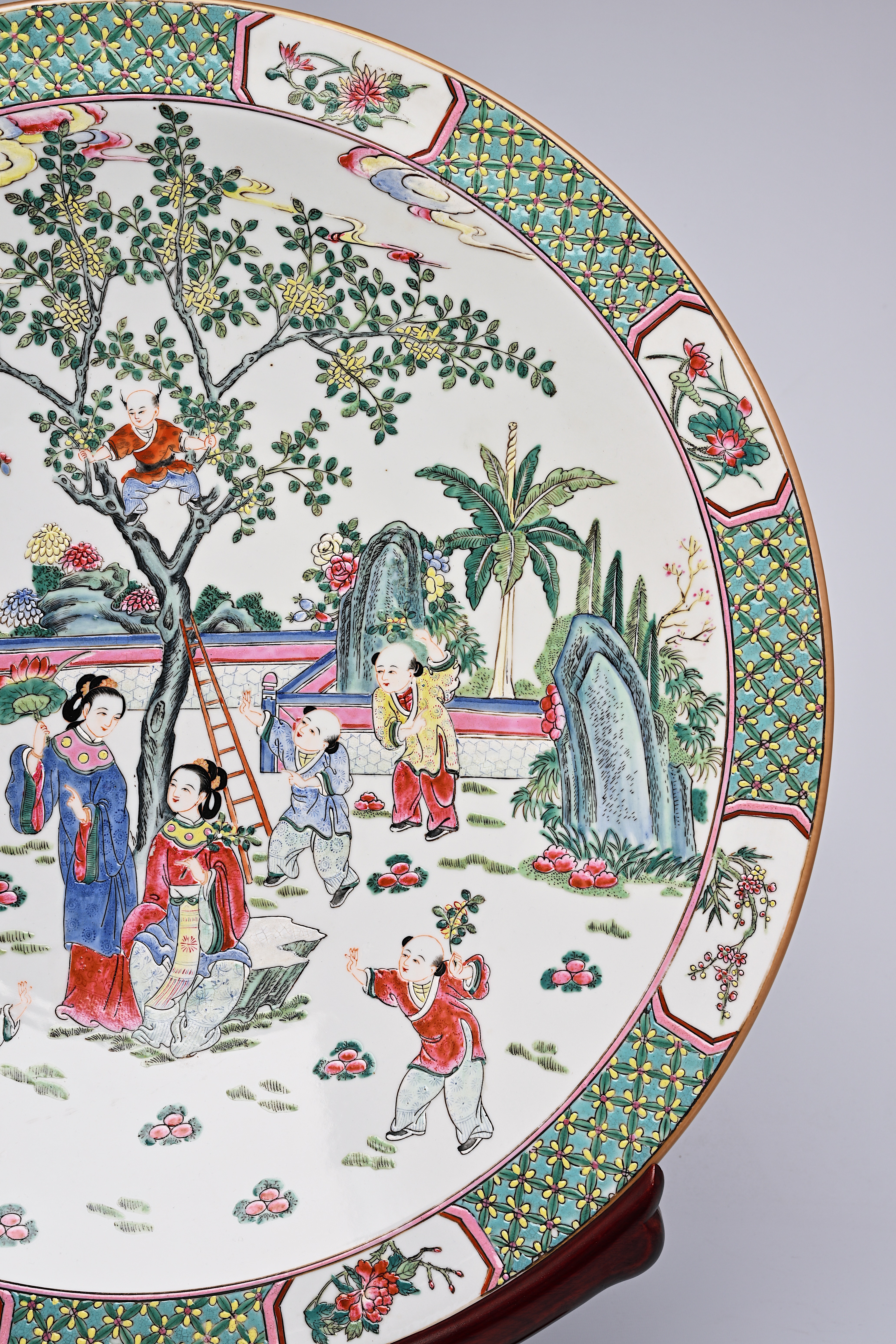 A large Chinese famille rose dish with ladies and children in a landscape, Qianlong mark, 20th C. - Image 12 of 16