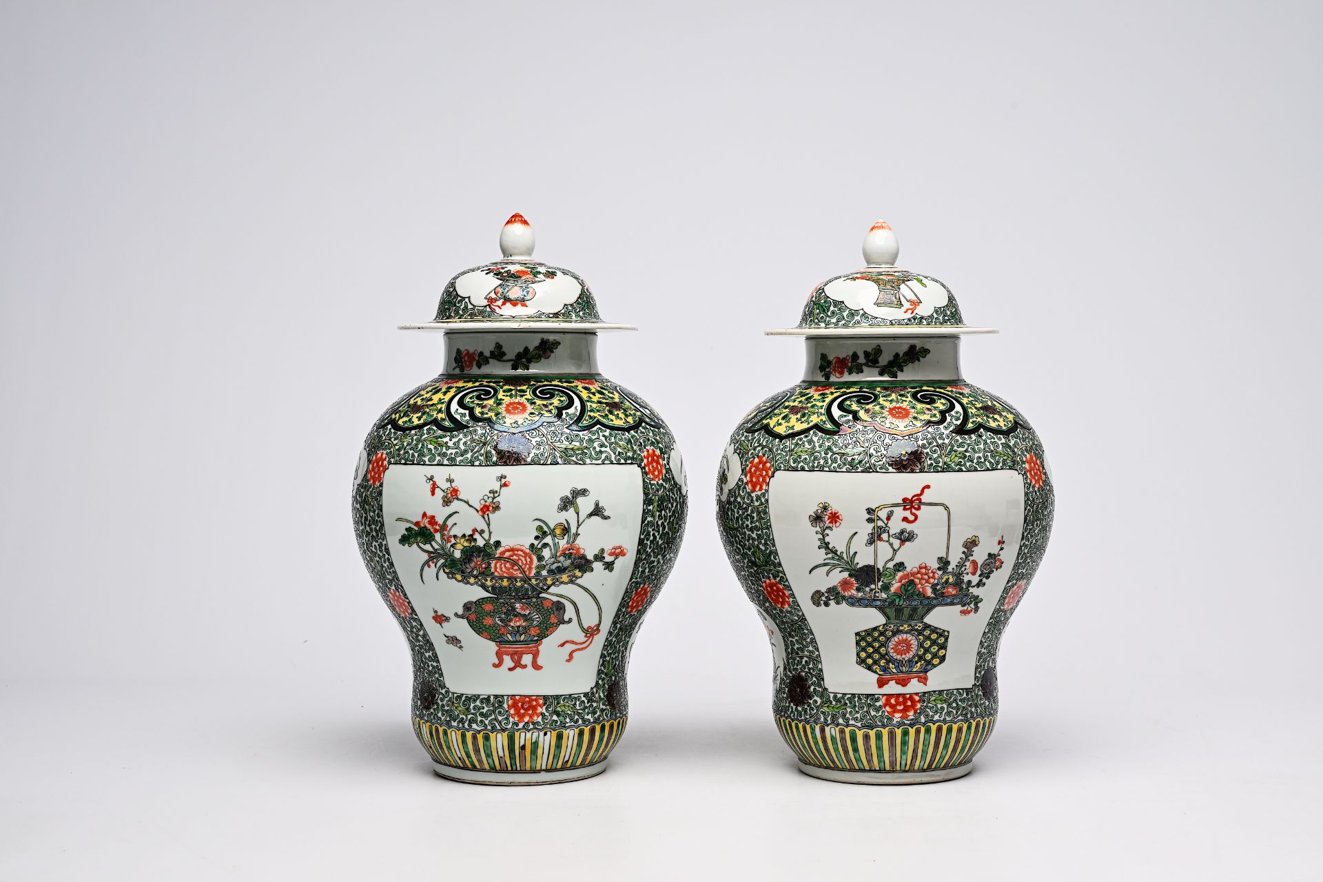 A pair of Chinese famille verte vases and covers with flower baskets and floral design, 19th C.