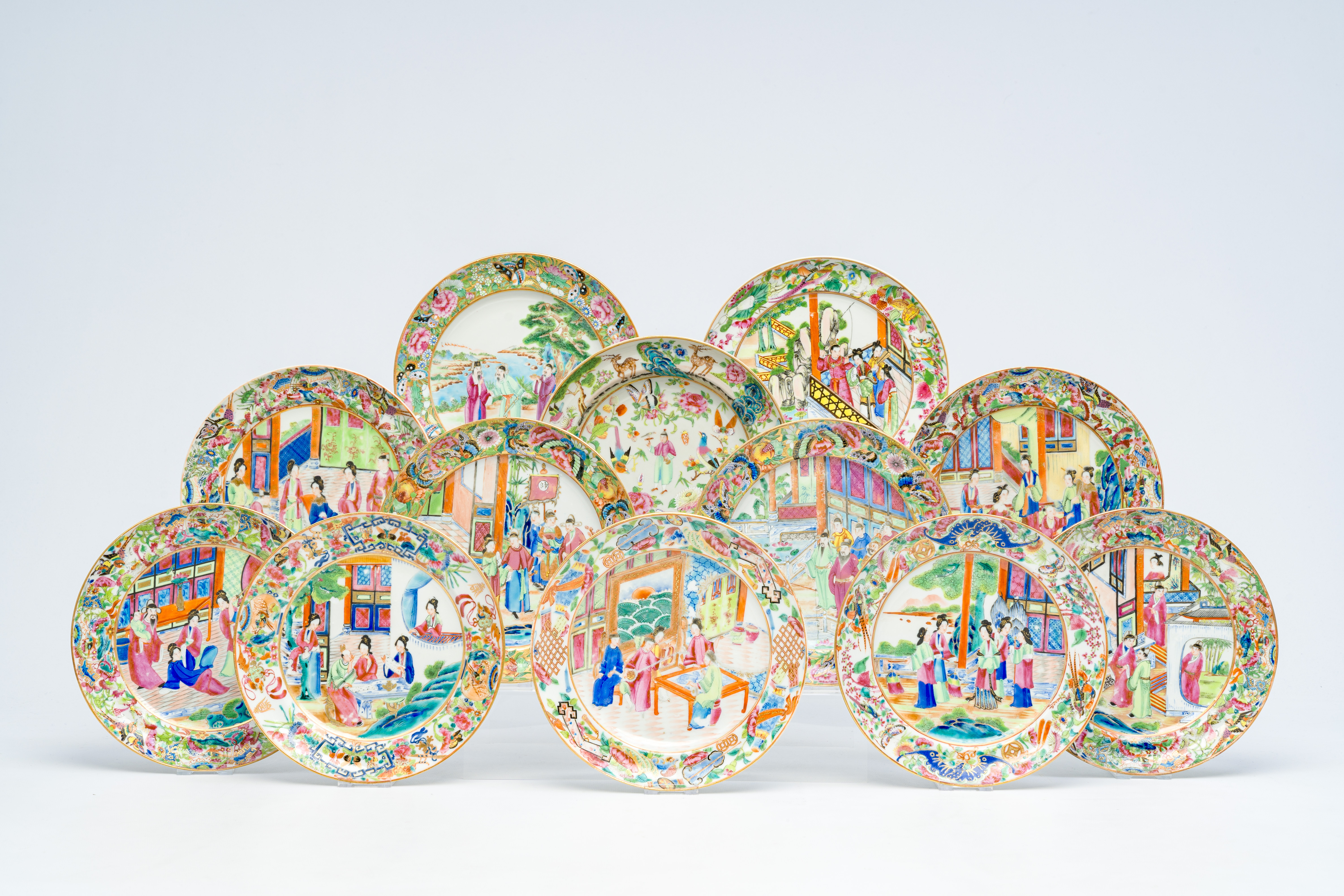 Twelve Chinese Canton famille rose plates with an animated design, 19th C.