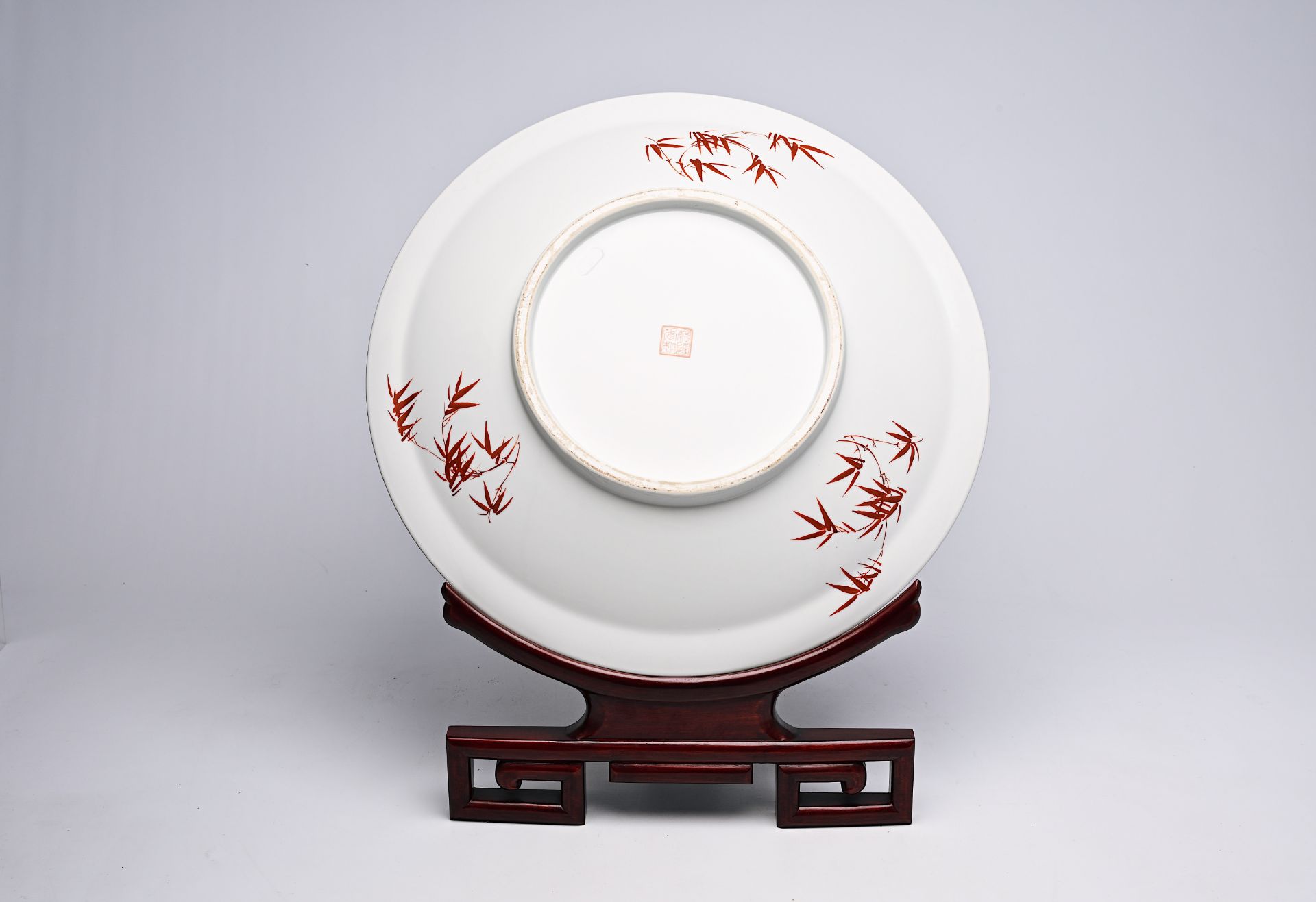 A large Chinese famille rose dish with ladies and children in a landscape, Qianlong mark, 20th C. - Image 3 of 16