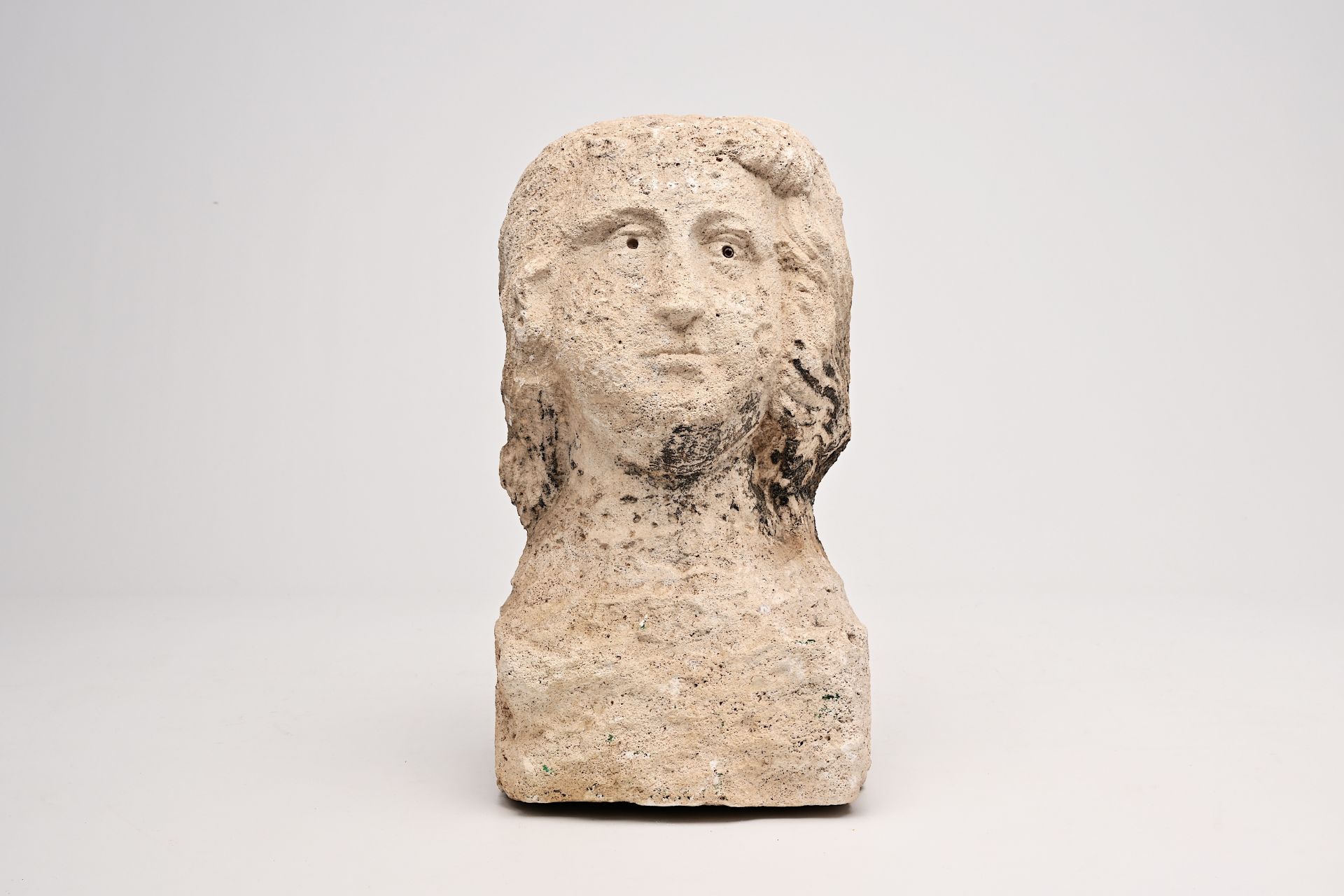An architectural stone sculpture of a man's head, probably 16th C.