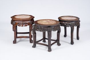 Three Chinese reticulated hardwood stands with marble tops, 20th C.