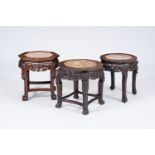 Three Chinese reticulated hardwood stands with marble tops, 20th C.