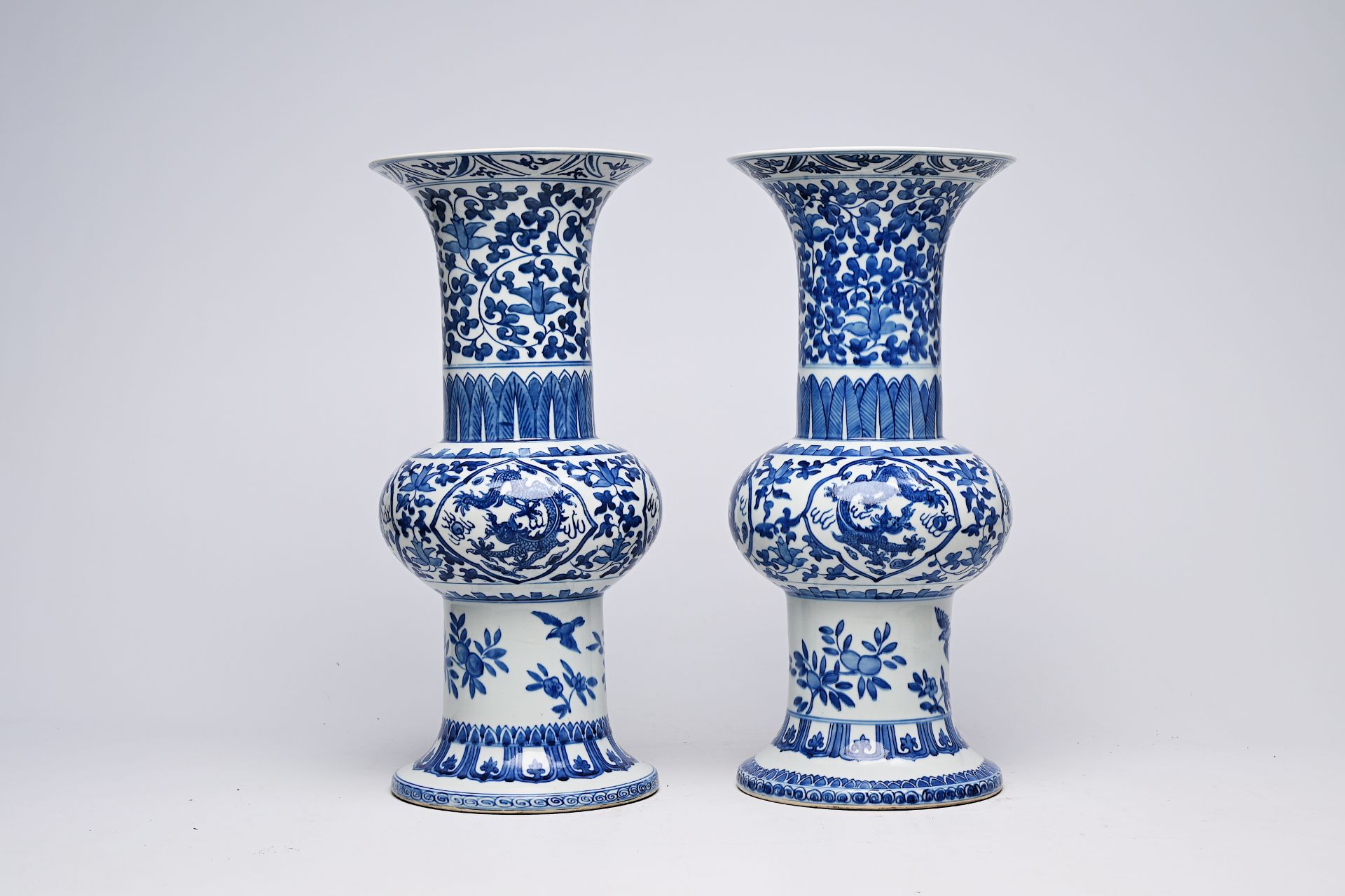 A pair of Chinese blue and white 'gu' vases with dragons and floral design, Qianlong mark, Republic, - Image 7 of 22