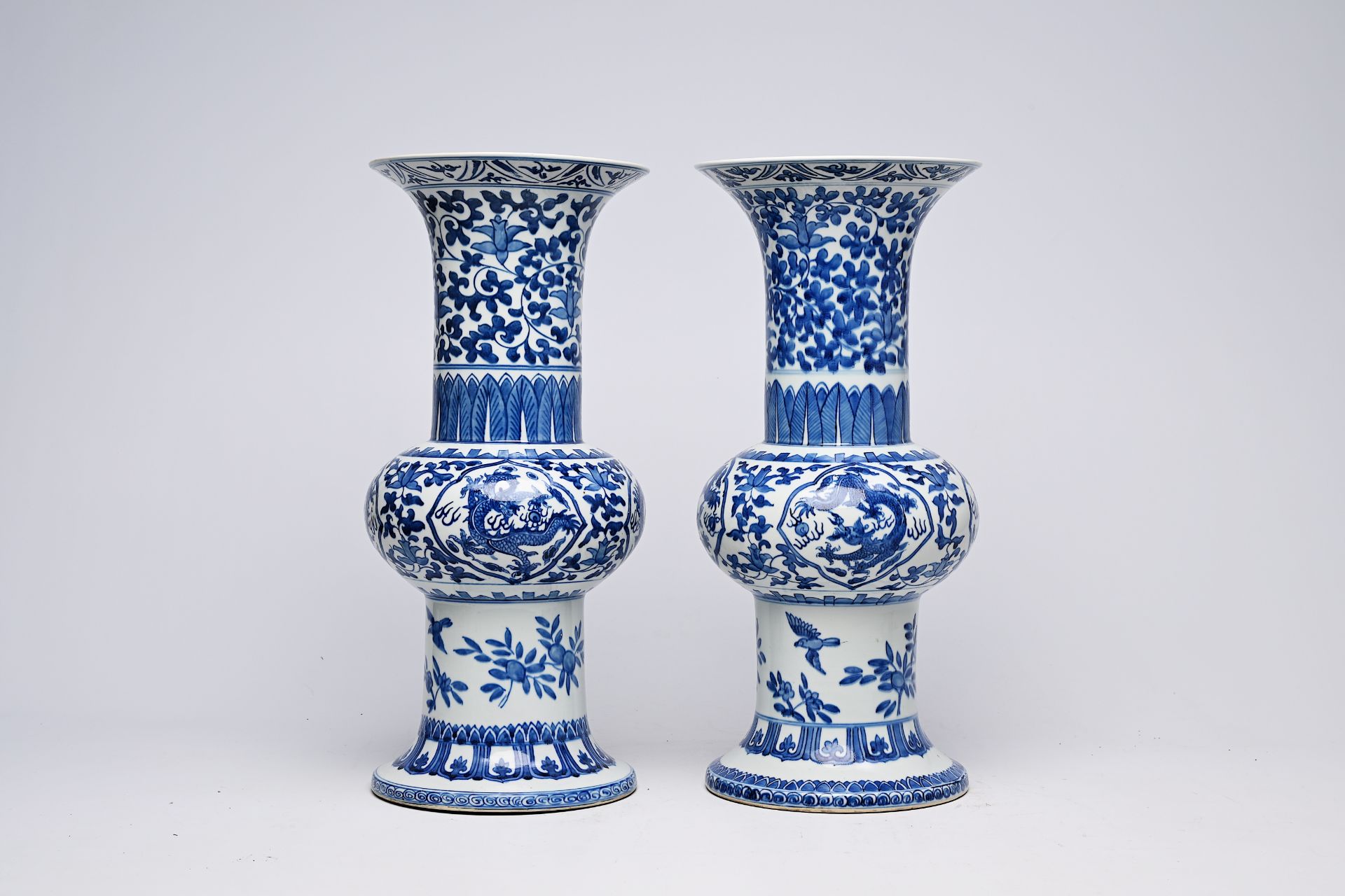 A pair of Chinese blue and white 'gu' vases with dragons and floral design, Qianlong mark, Republic, - Image 9 of 22