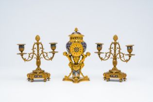 A French gilt bronze and cloisonne three-piece clock garniture with putti, 19th C.