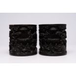 A pair of Chinese richly carved wooden brush pots, 19th/20th C.