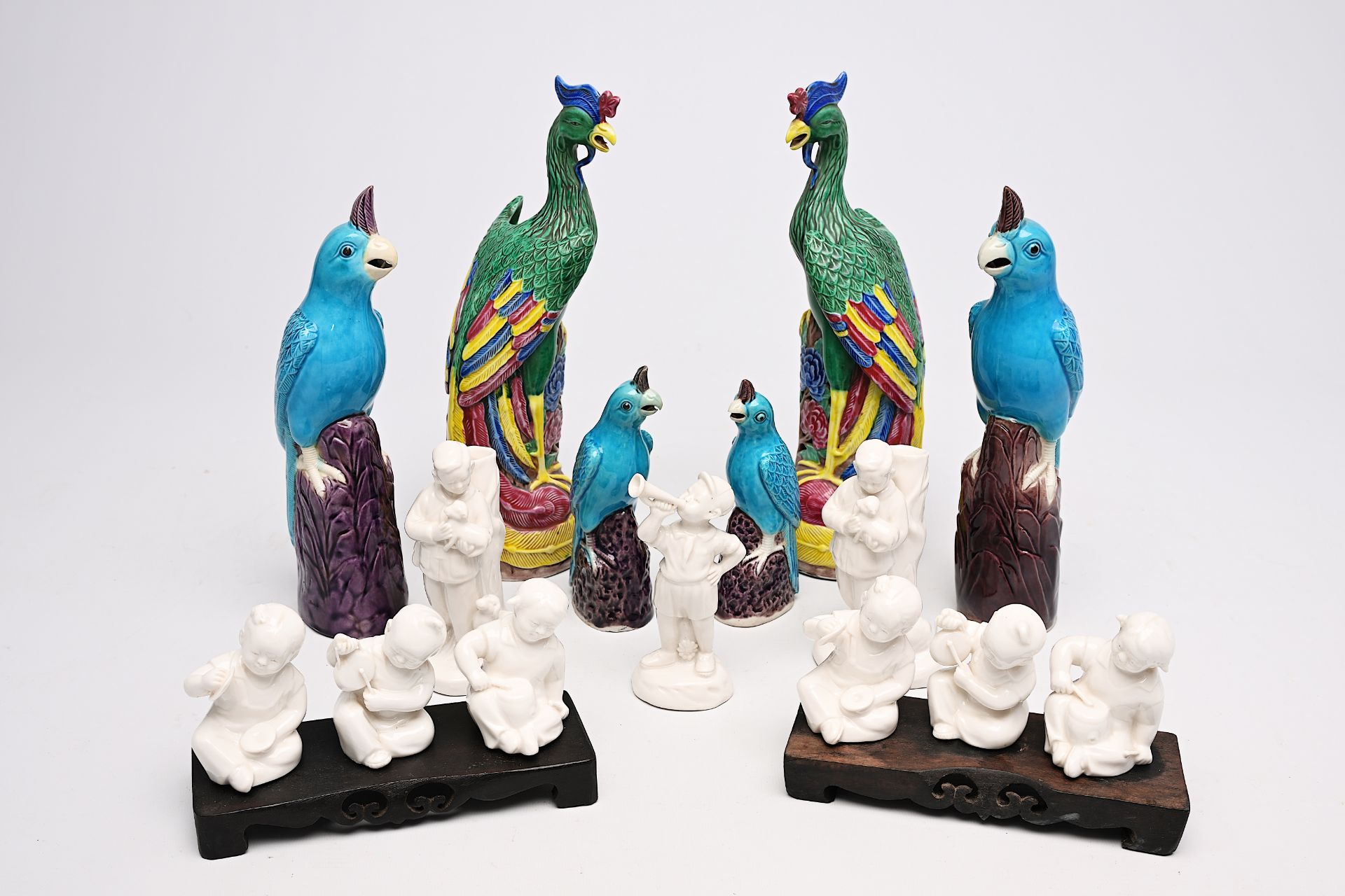 A pair of Chinese famille rose phoenixes, two pairs of turquoise parrots and nine blanc de Chine fig