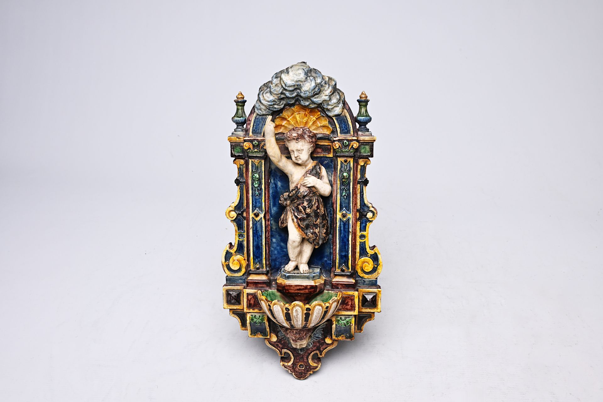 An English Gothic revival Palissy style polychrome decorated earthenware holy water font, probably M
