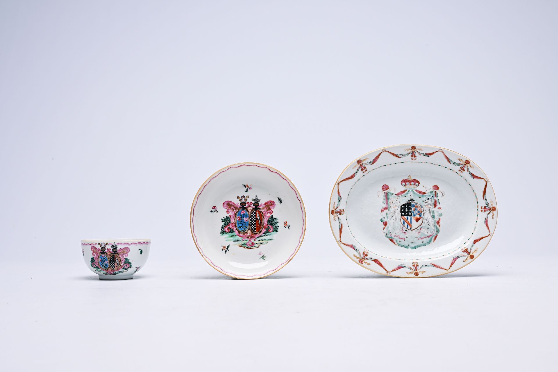 A Chinese famille rose armorial oval dish and a cup and saucer, Qianlong