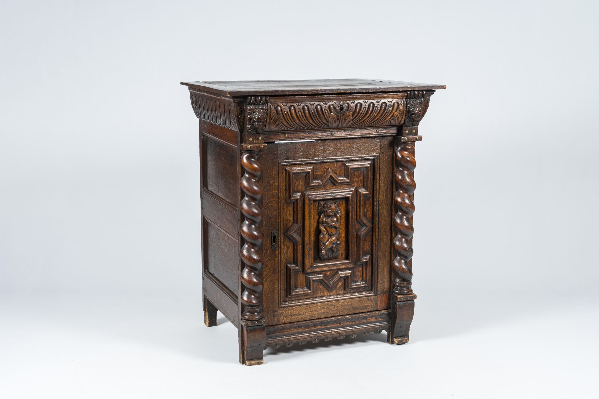 A Flemish oak single-door cupboard composed of Renaissance ornaments, 19th C.