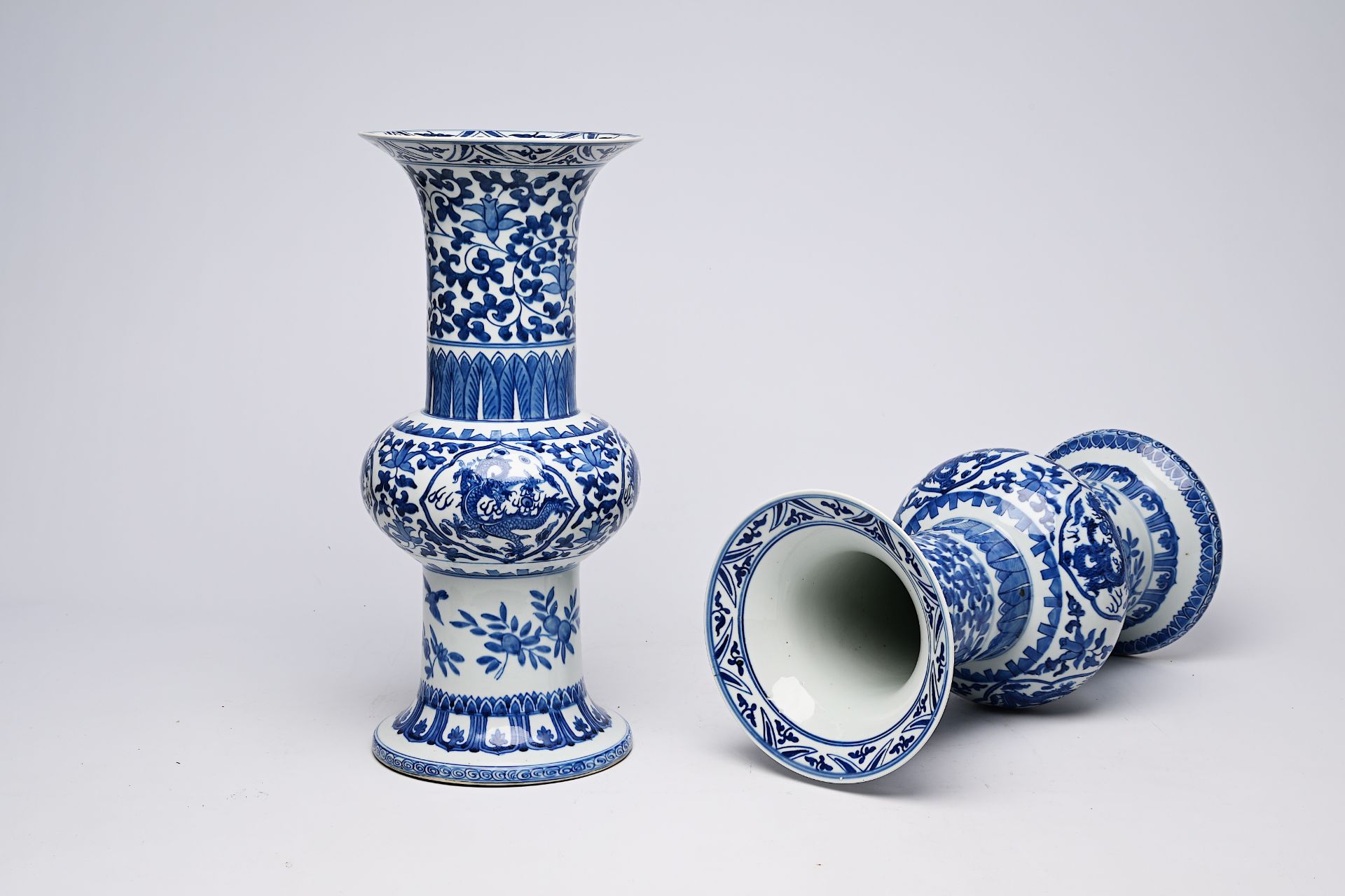 A pair of Chinese blue and white 'gu' vases with dragons and floral design, Qianlong mark, Republic, - Image 13 of 22