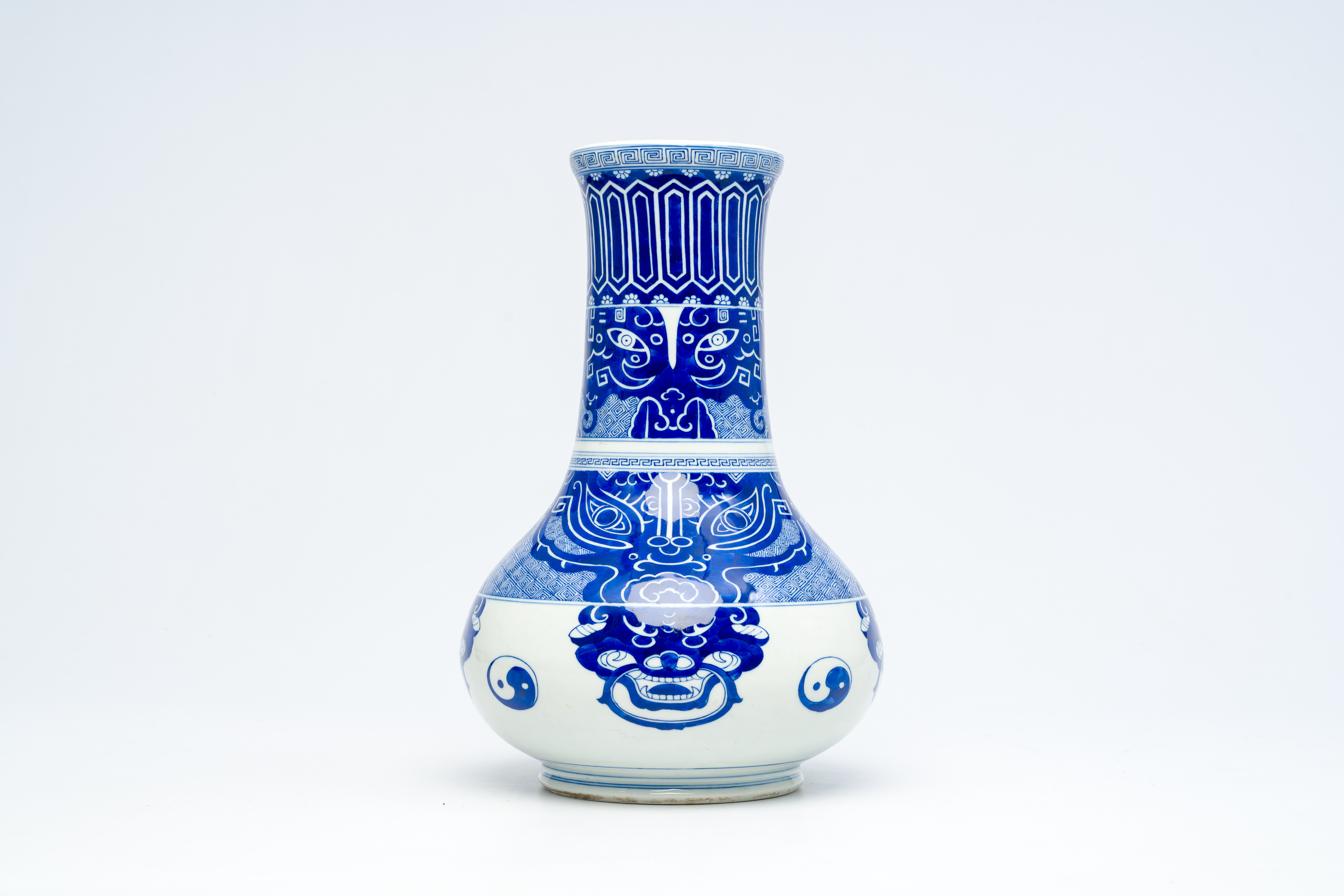 A Chinese peer-shaped blue and white 'taotie masks' vase, 20th C.