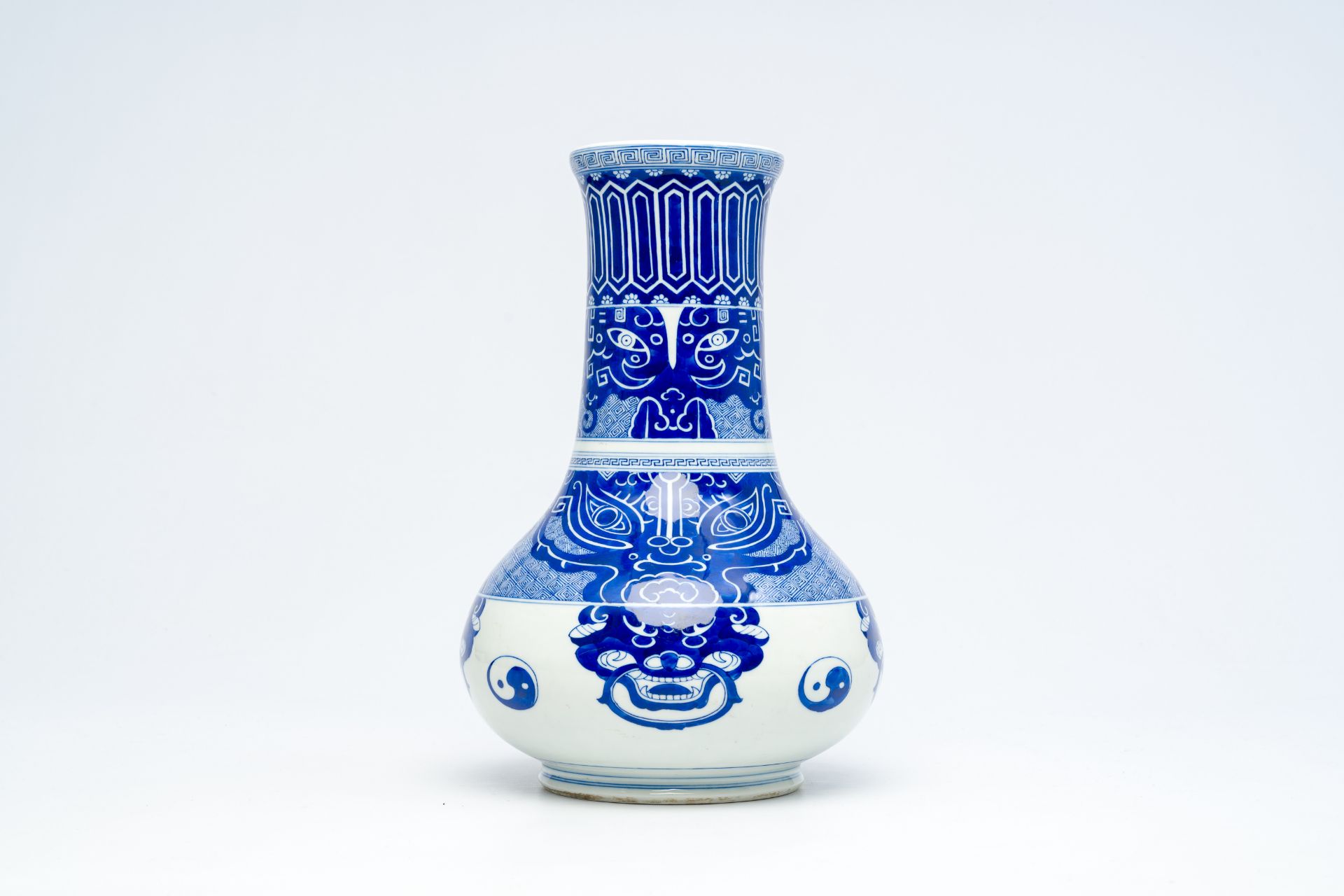 A Chinese peer-shaped blue and white 'taotie masks' vase, 20th C.