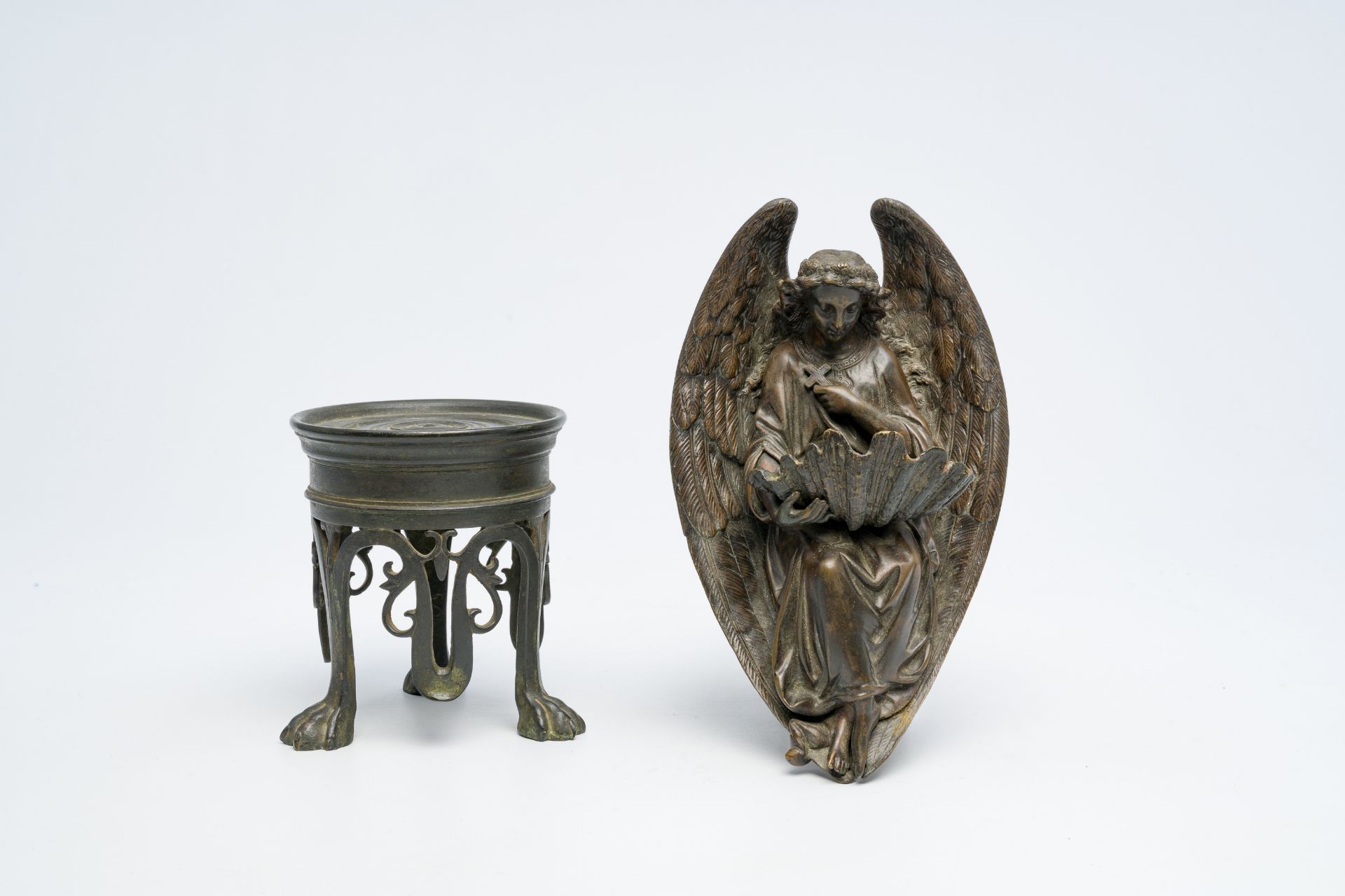 An Italian 'Grand Tour' patinated bronze tripod stand and a holy water font in the shape of an angel